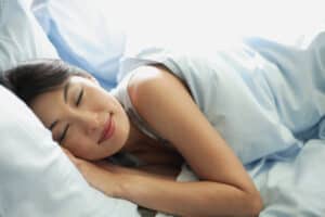 woman sleeping sideways after recovery from surgery