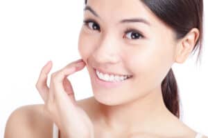 asian girl smiling after flat nose surgery