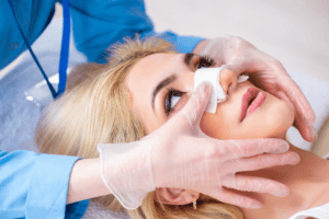 young woman is prepared for nose surgery